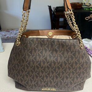 Michael Kors shoulder bag, has 3 separate compartments for all your goodies.